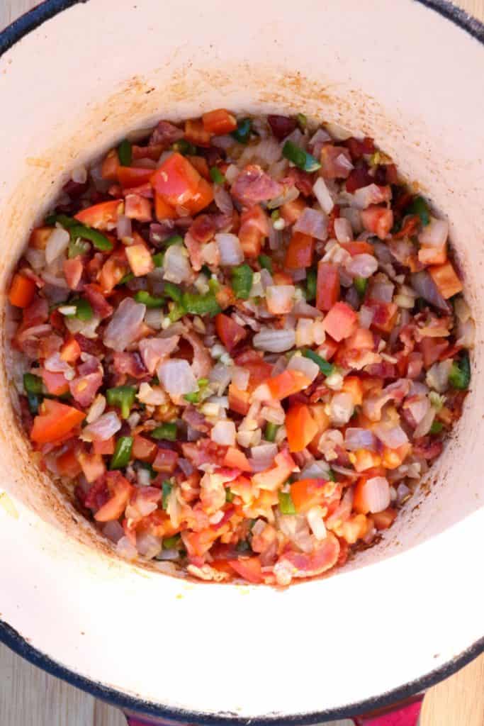 Diced bacon, jalapeño, tomato, onion and garlic in a small pot for lentil soup