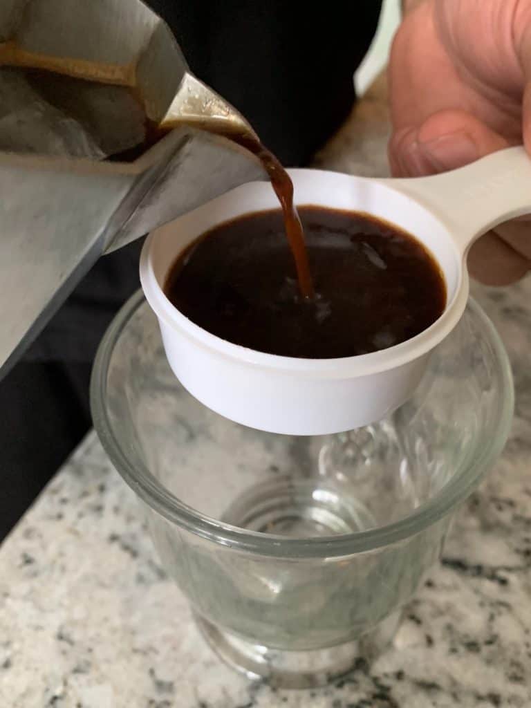 Pouring coffee in a measuring cup