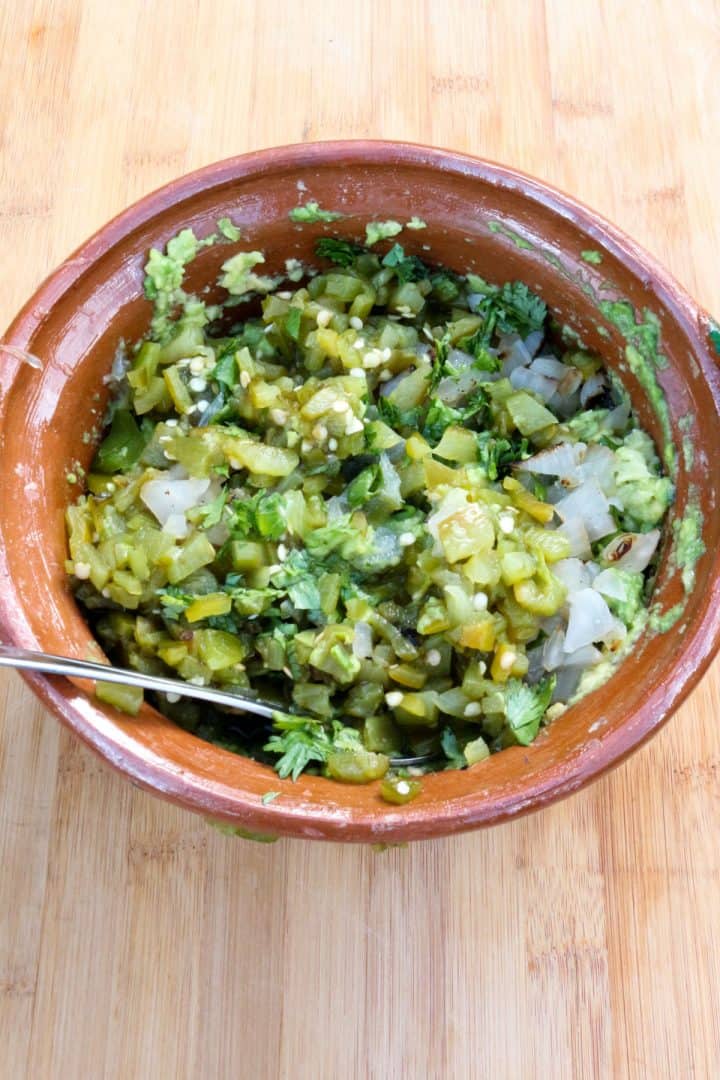 Green Chile Guacamole ingredients mixed in a bowl