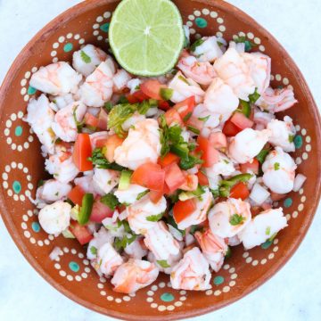 Shrimp Ceviche in a brown bowl with a lime.