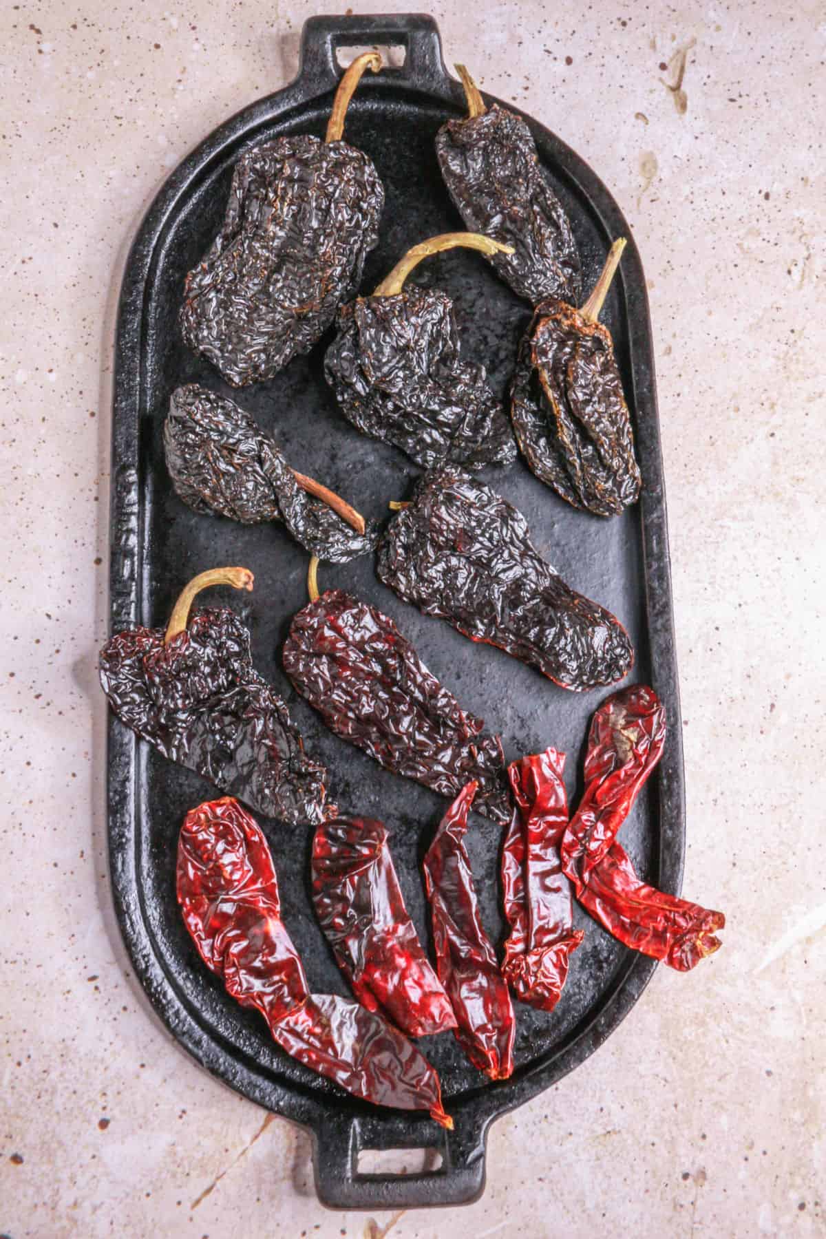 toasting dried chiles on a comal for mole