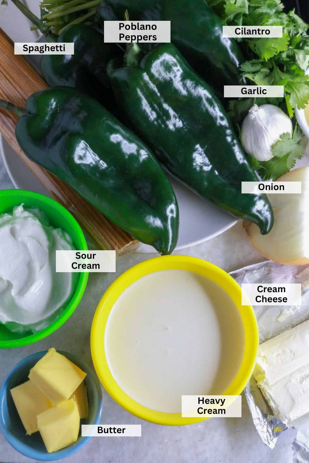 Ingredients for Espagueti Verde (Mexican Green Spaghetti): poblano peppers, garlic, onion, spaghetti, sour cream, milk, cream cheese, butter