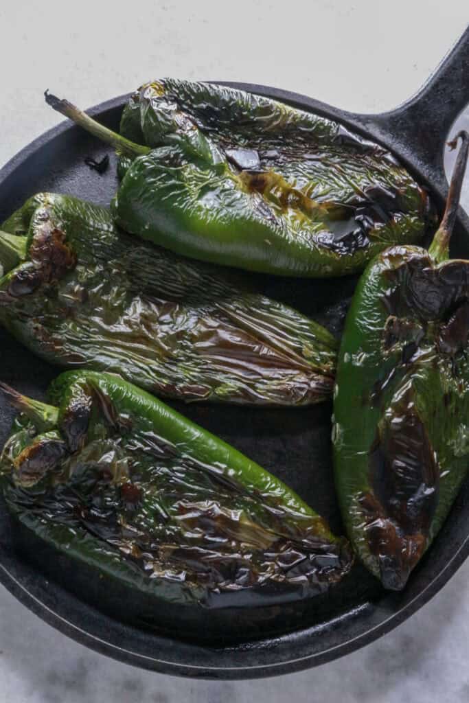 Roasted poblano peppers on a comal