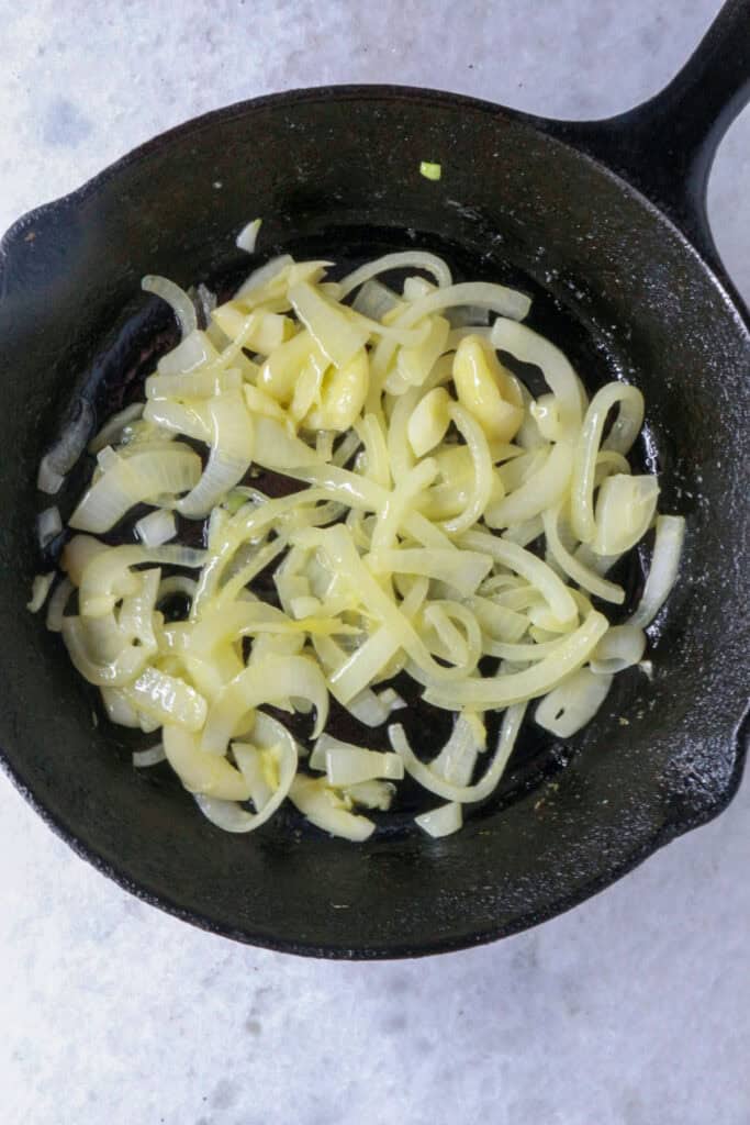 Cast-iron skillet with sautéed onions and garlic