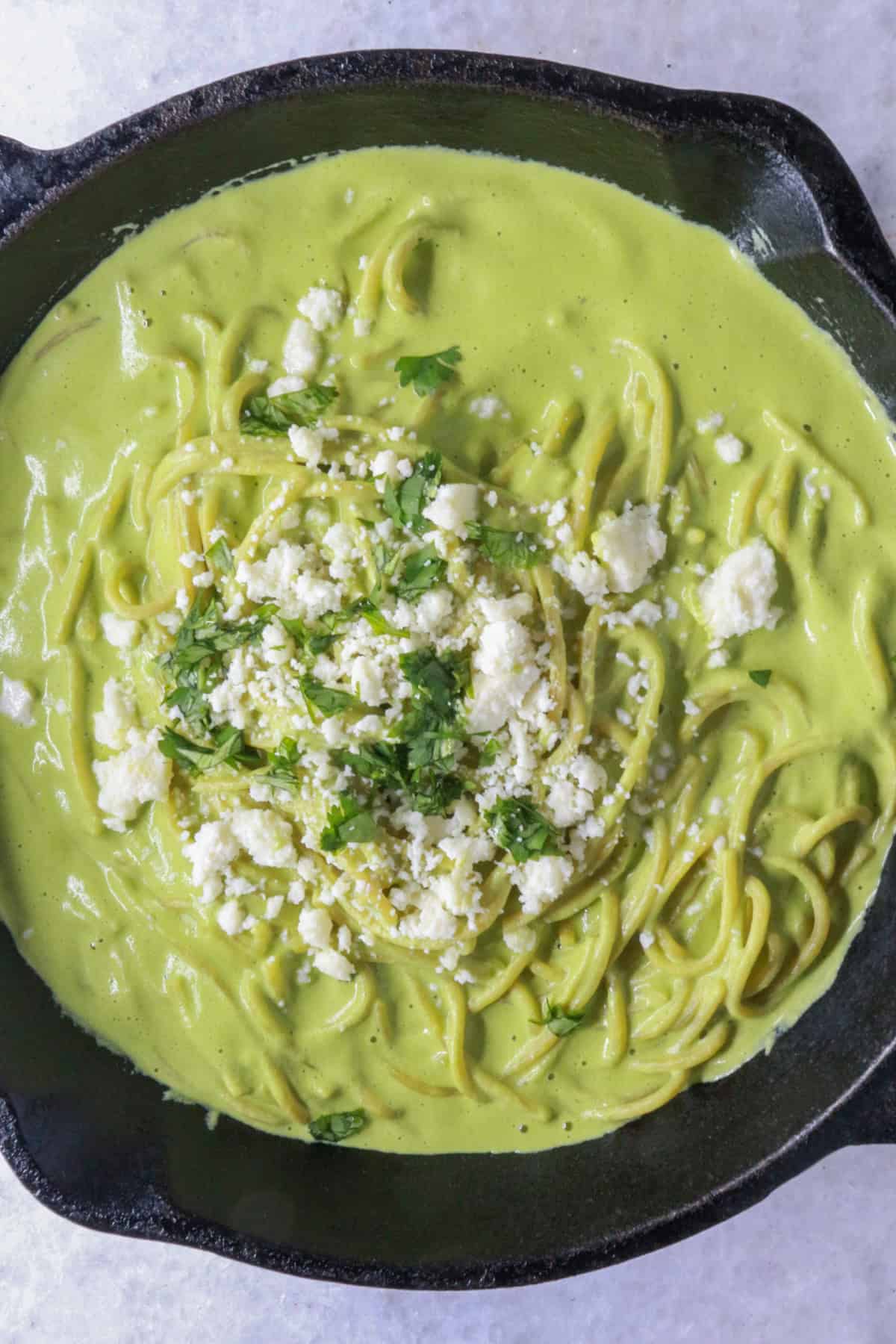 Espagueti Verde (Mexican Green Spaghetti) in a cast-iron skillet