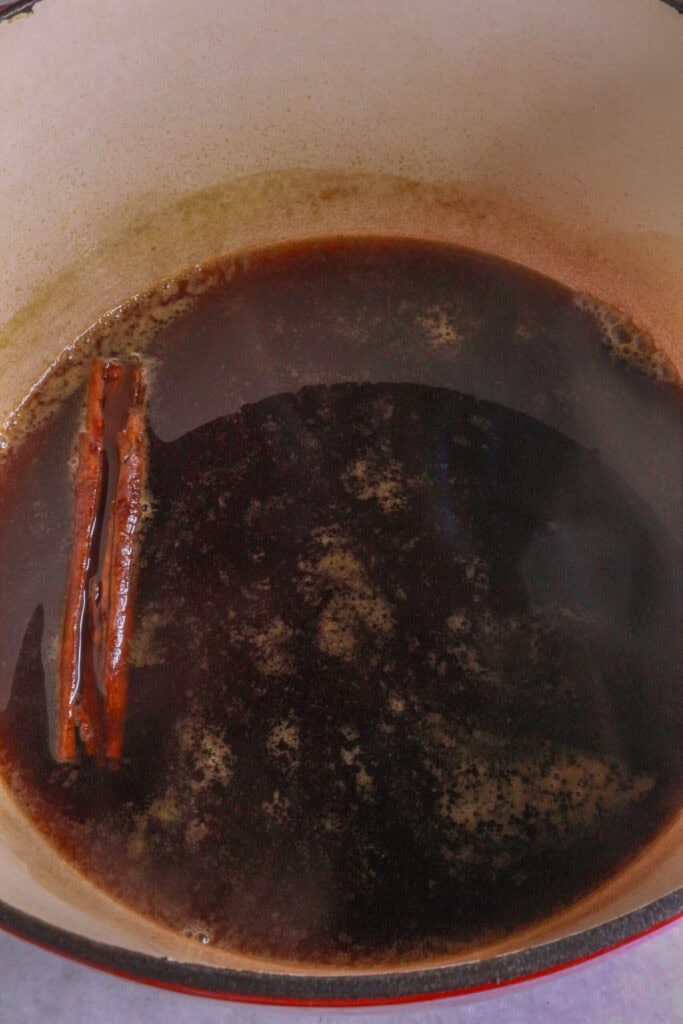 Boil cinnamon and piloncillo in a pot of water