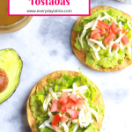 Avocado Tostadas with containers of lettuce, tomato, salsa and half of an avocado around it