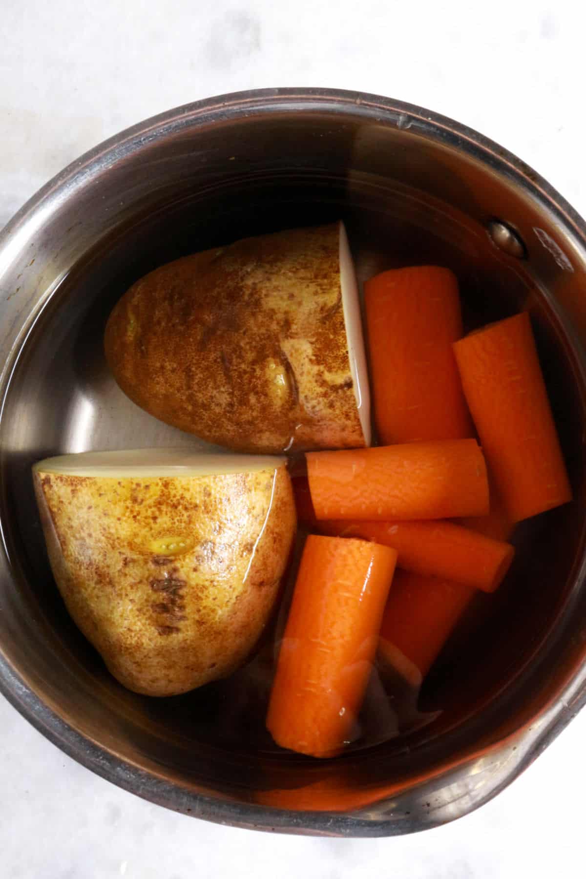 Boiling potatoes and carrots in water