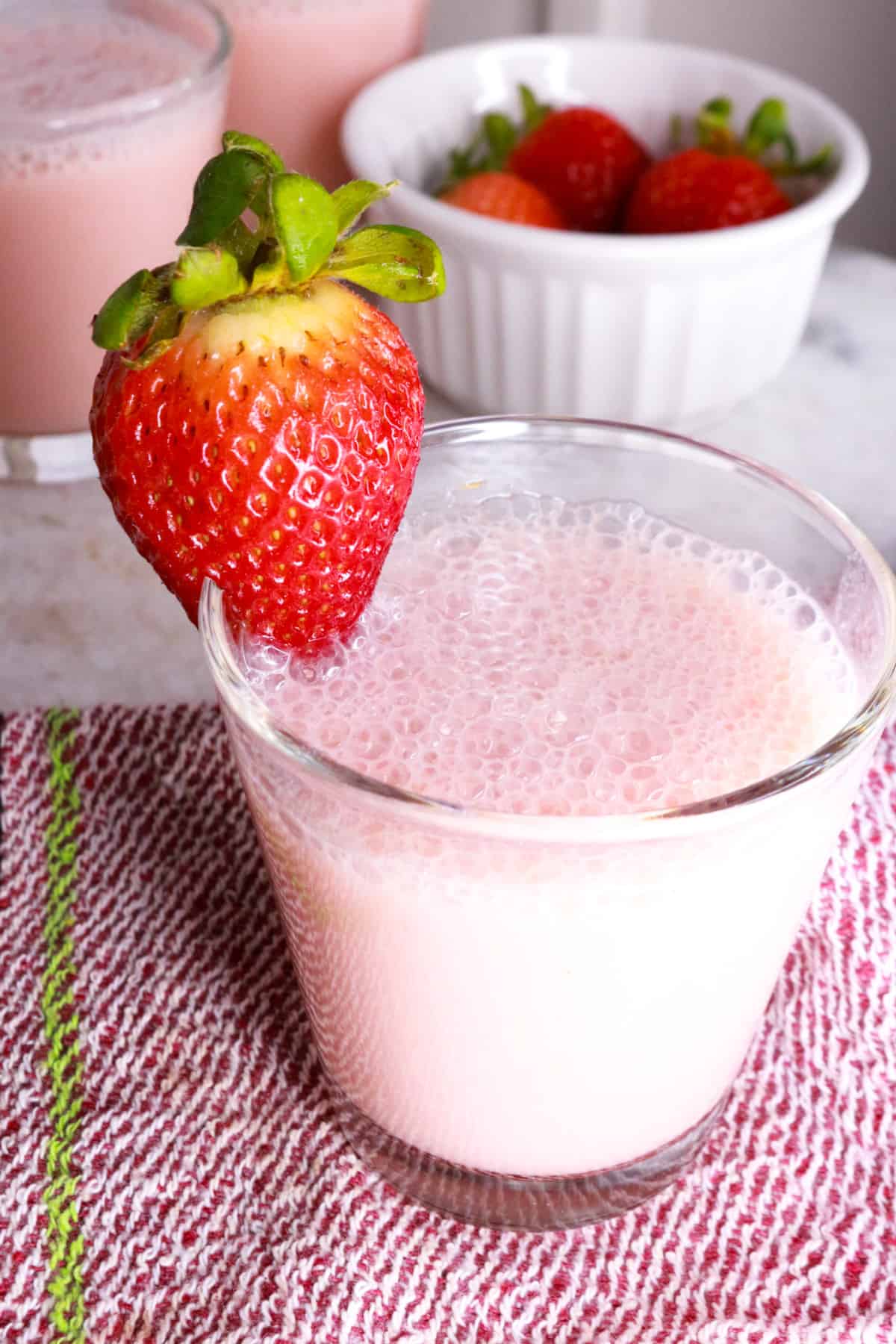 Creamy Strawberry Agua Fresca in a glass with a strawberry garnish