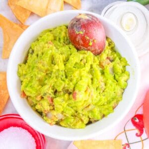 Fire Roasted Guacamole surrounded by tortilla chips and vegetables