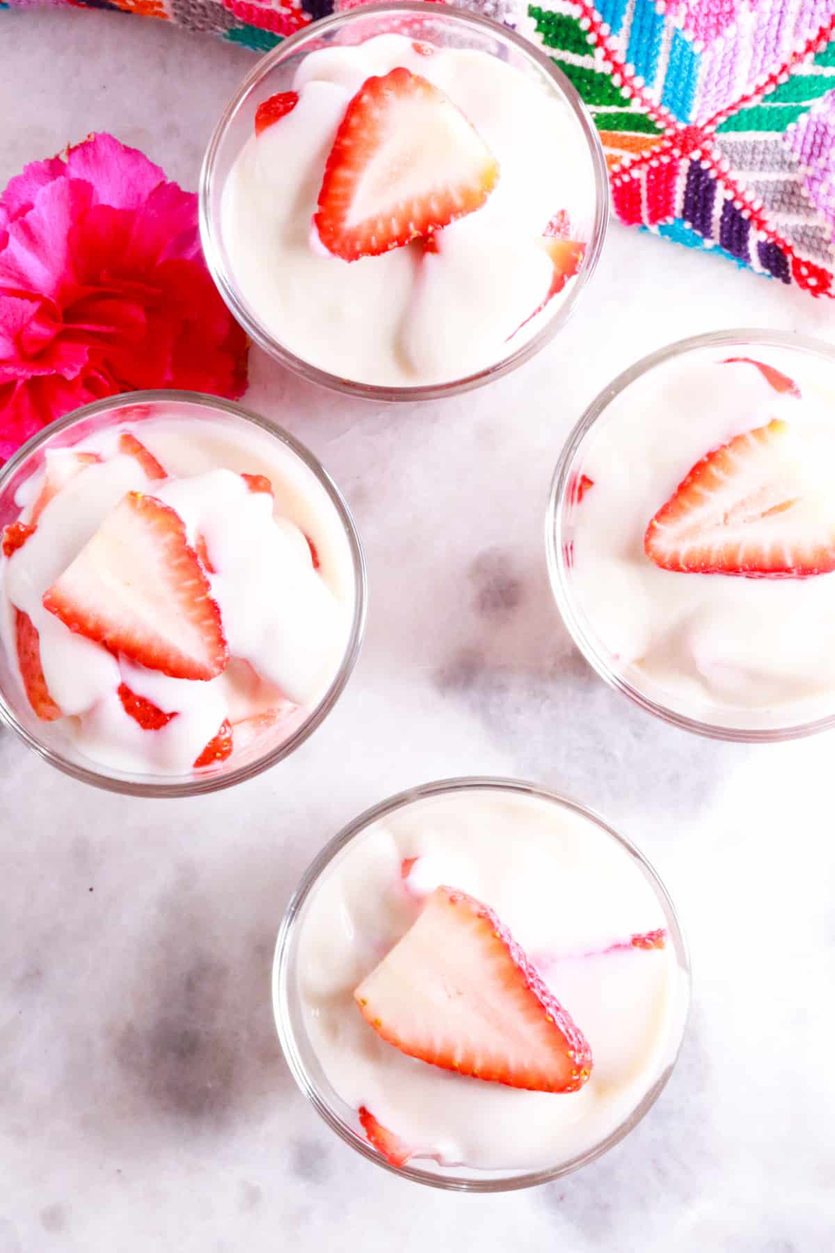 Shot from above of four glasses with fresas con crema