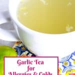 White mug with garlic tea on a coaster