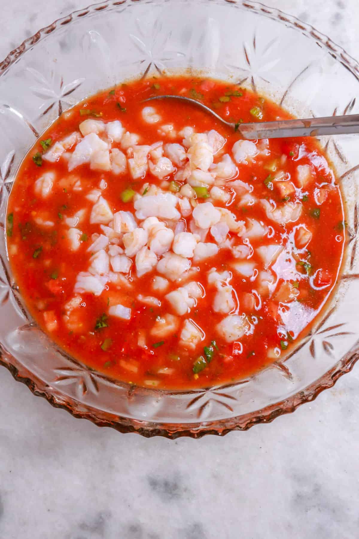 mixing together ingredients for coctel de camarones