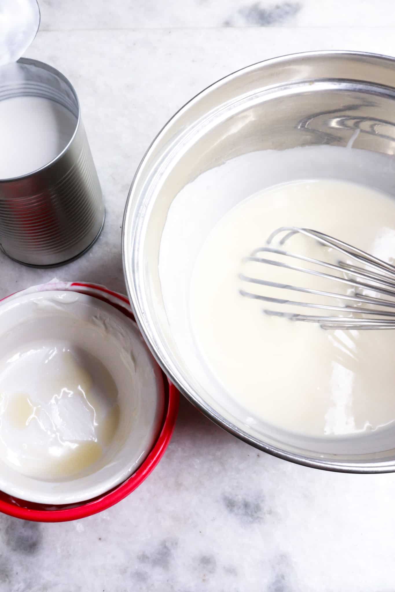 A bowl with a whisk mixing the cream for the duraznos con crema recipe