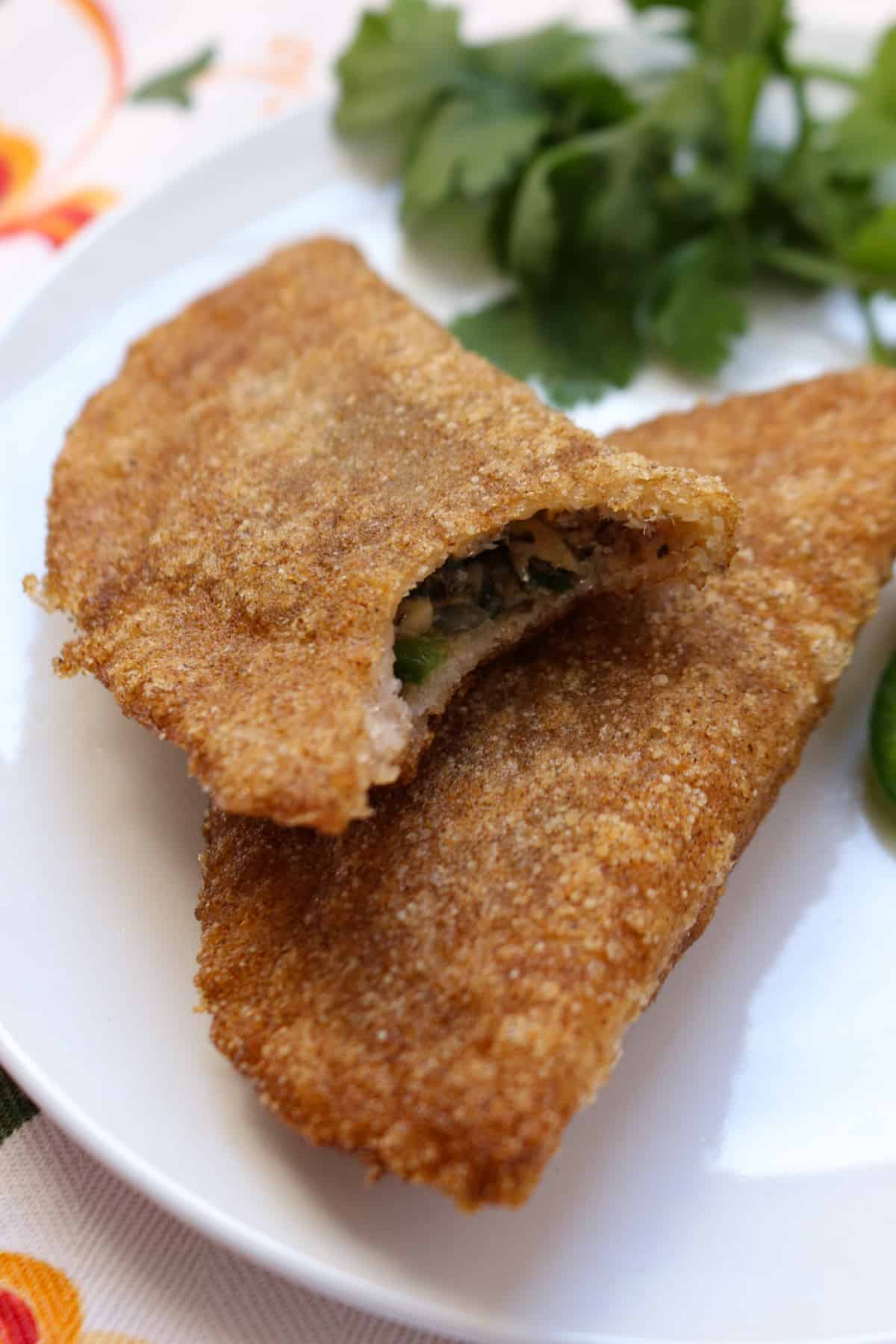 Two gluten-free sardine empanadas on a plate