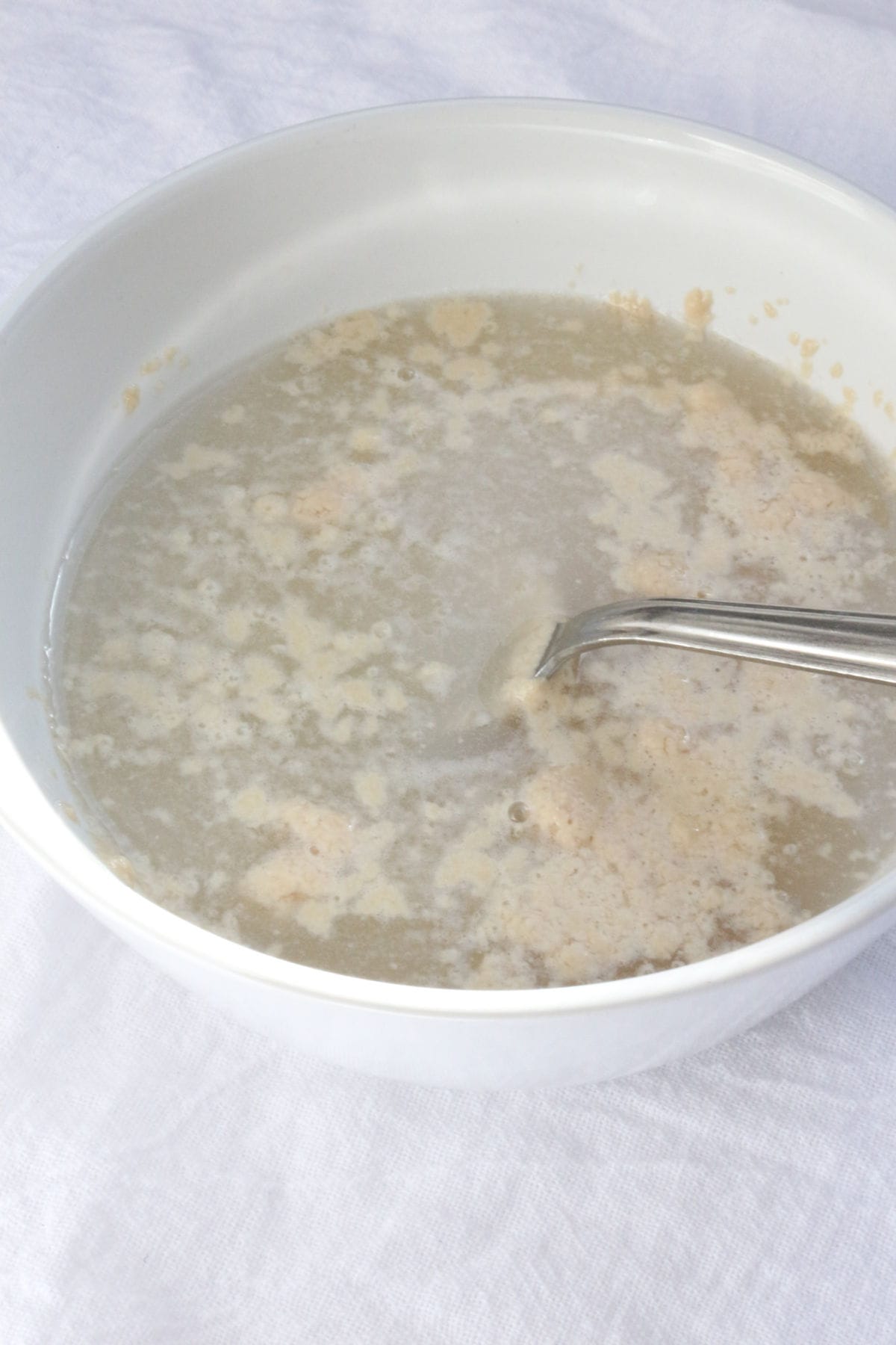 A bowl with water, yeast and sugar