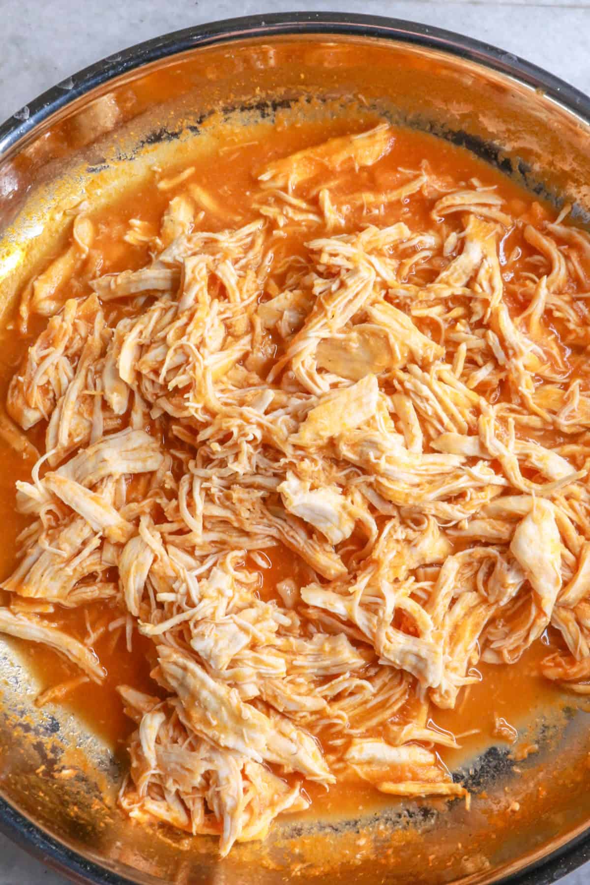 Chicken simmering in tomato sauce