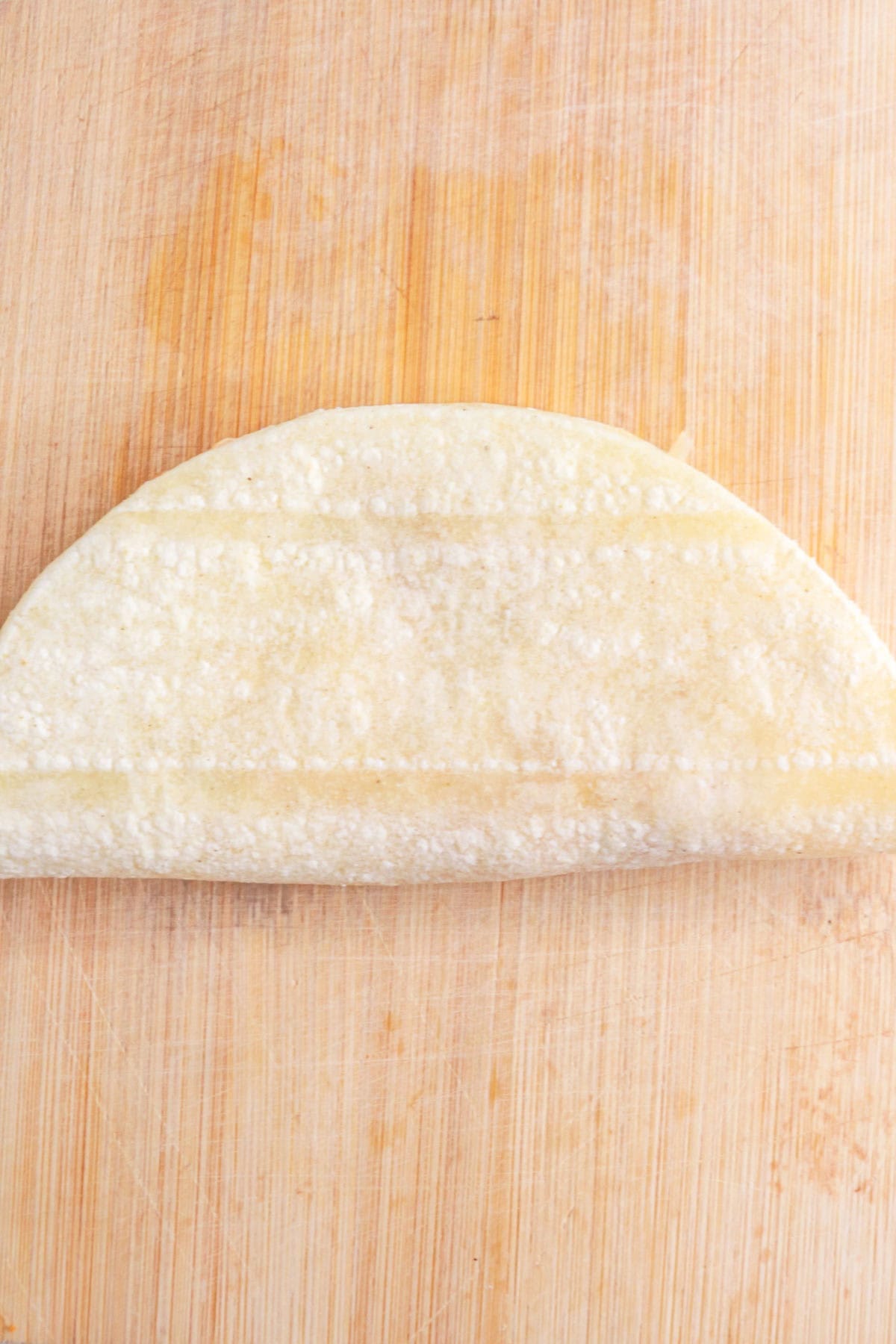 Folded chicken taco ready to be fried