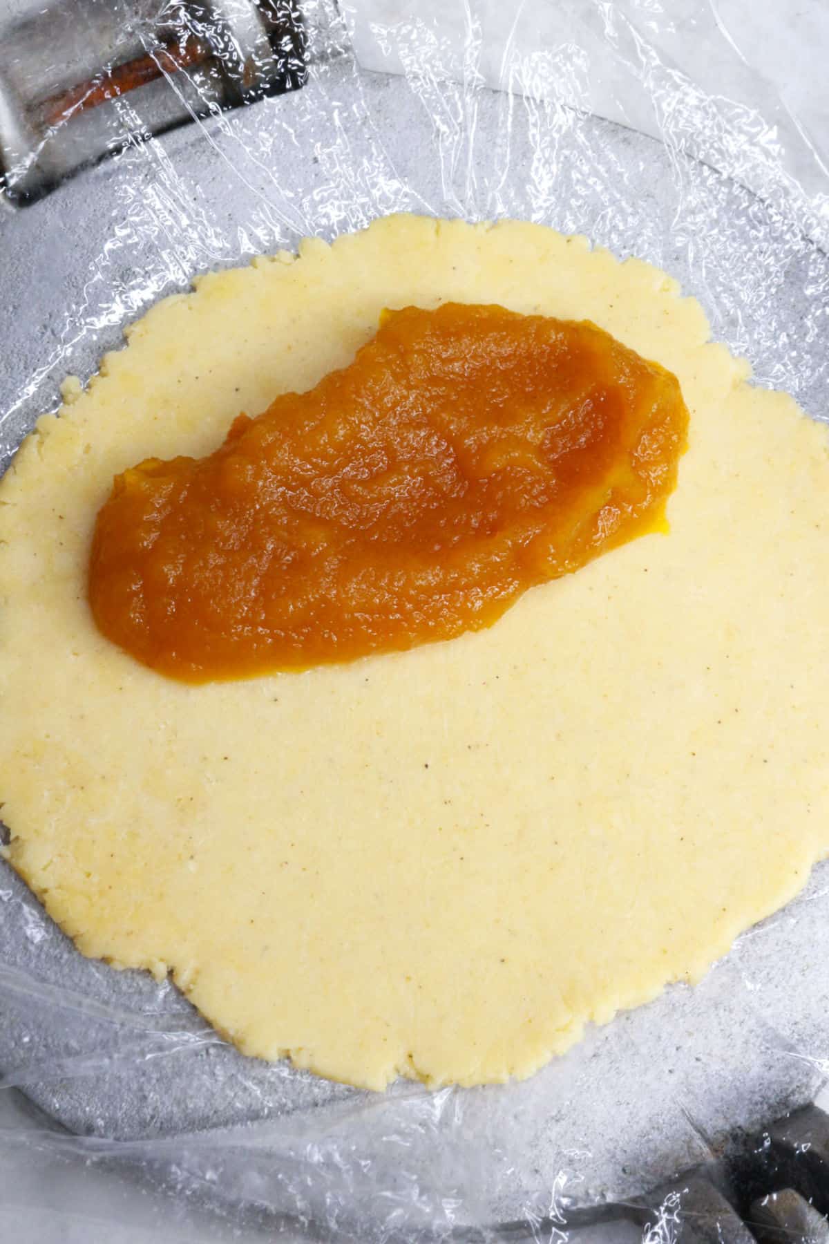 Pumpkin filling on a round of dough for empanadas