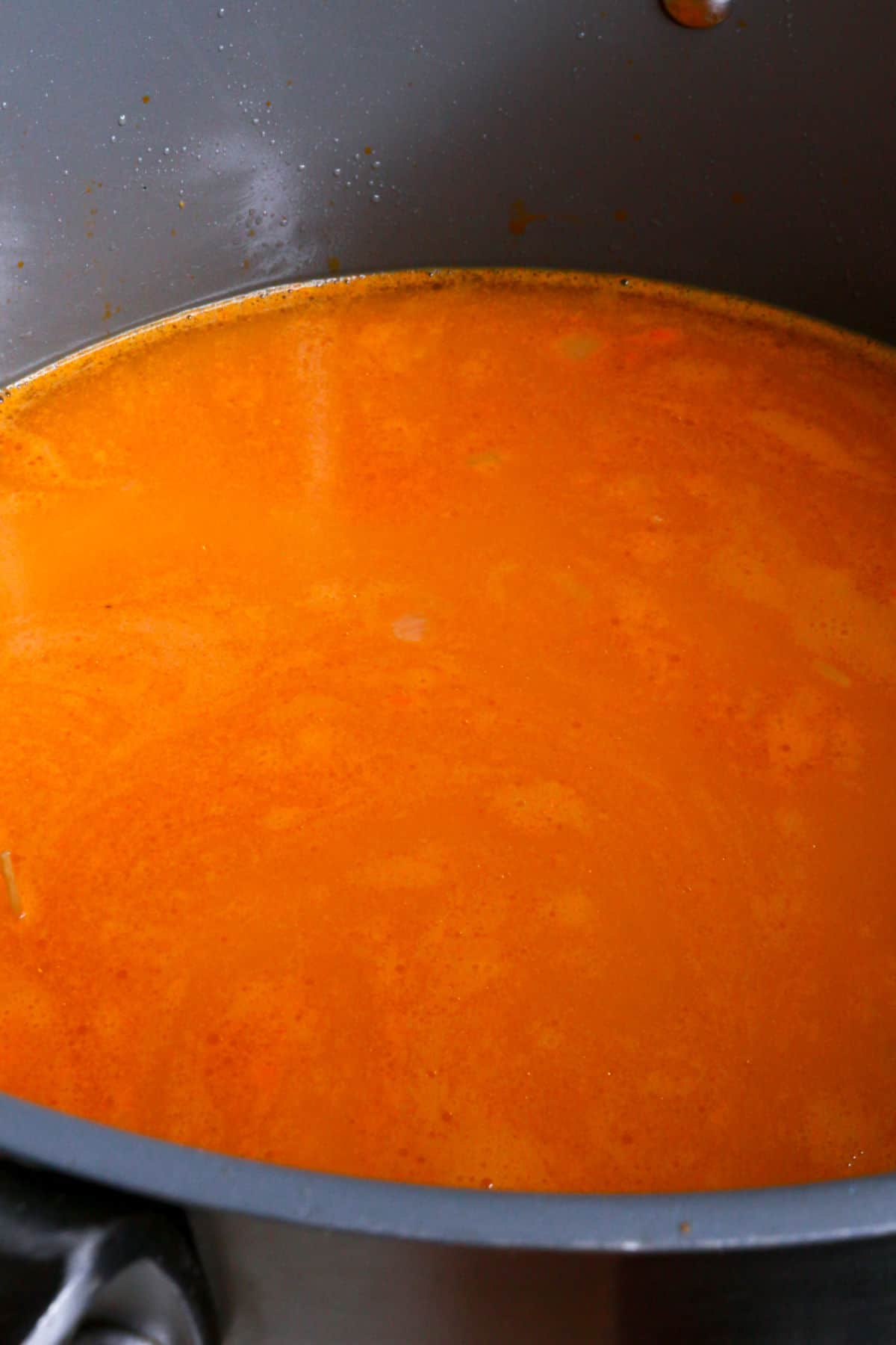 Sopa de fideo broth simmering in a large pot