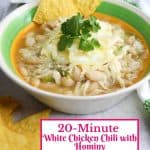 Bowl of white chicken chili with hominy with garnishes and tortillas chips