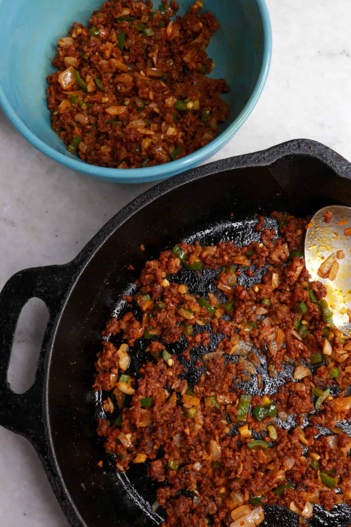 Chorizo with veggies in a bowl and in a cast-iron skillet