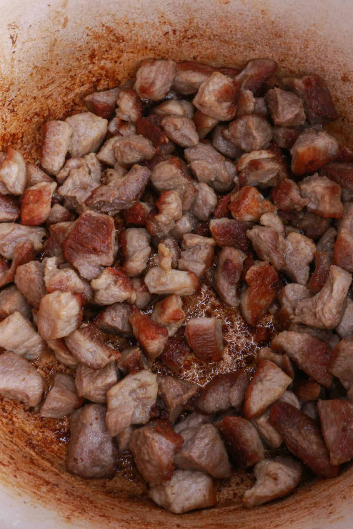 Pieces of golden-brown pork in a pot