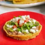 Sopes de frijoles on a red plate