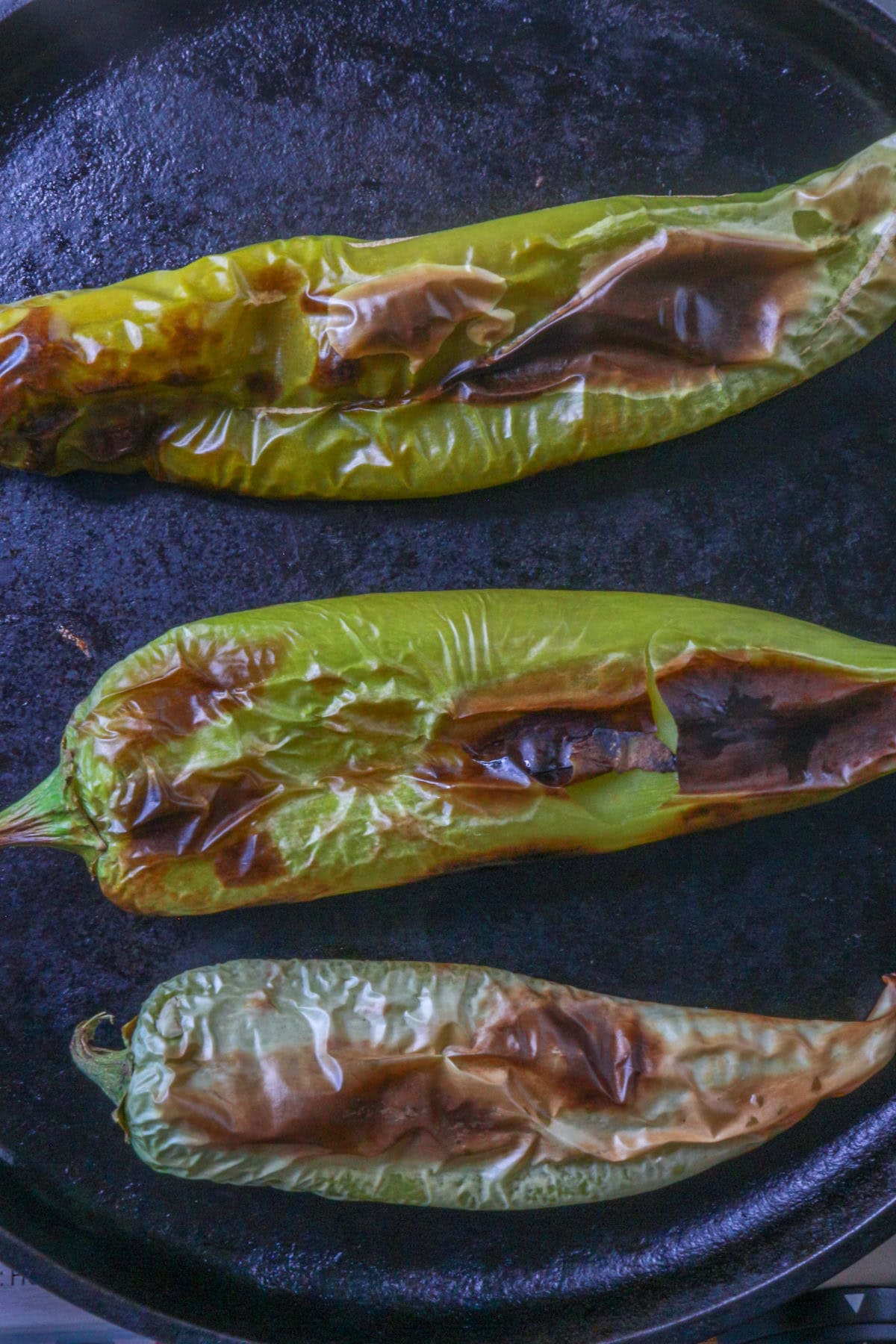 Roasting chiles on a cast-iron comal