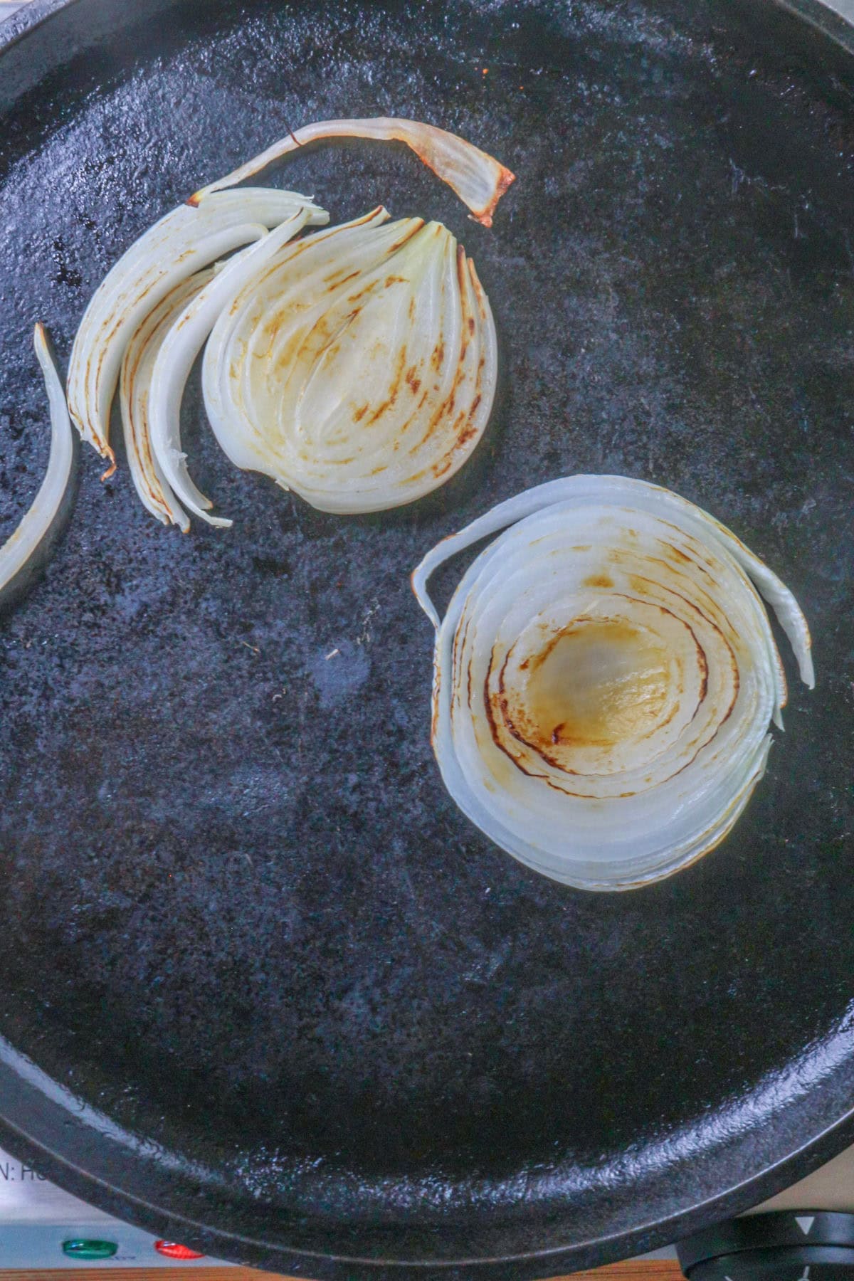 Roasting onion on a cast-iron comal