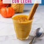 Mexican pumpkin arroz con leche in a glass cup garnished with a cinnamon stick