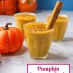 Pumpkin arroz con leche in a glass cup garnished with a cinnamon stick