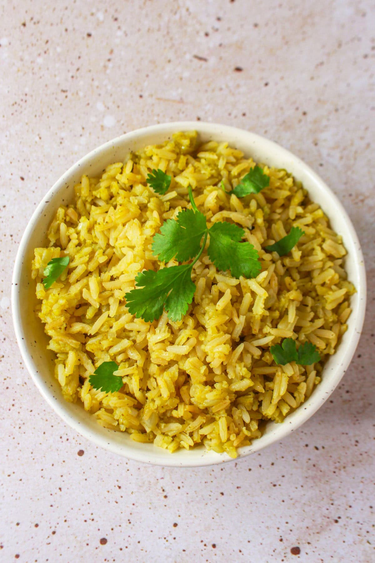 Plated poblano rice and garnished with fresh cilantro