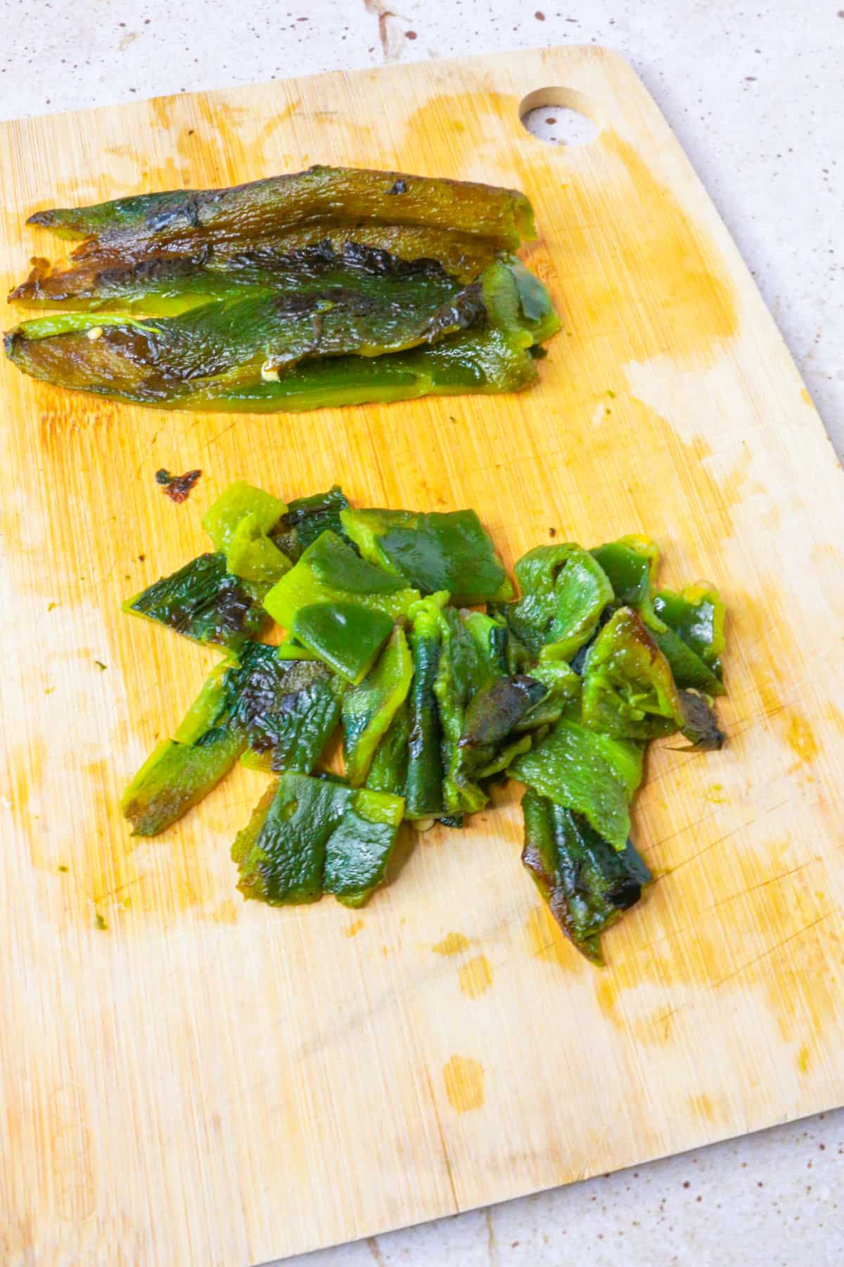 Chopped, roasted poblanos on a cutting board
