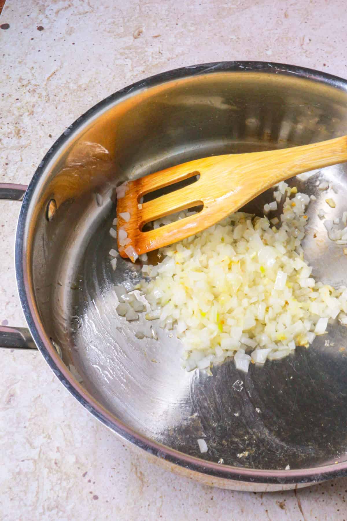 Sautéing diced garlic and onion in a pan
