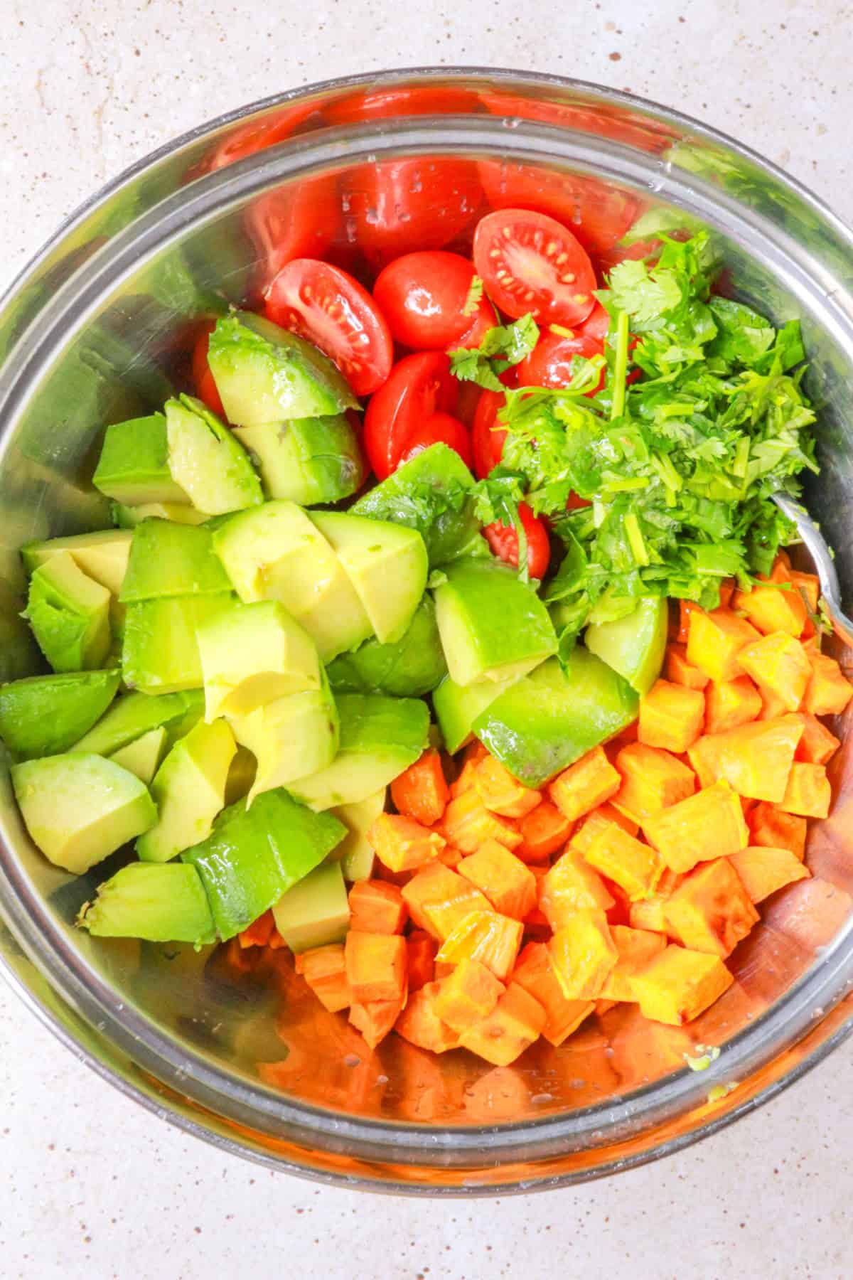 Chopped ingredients for sweet potato salad in a mixing bowl