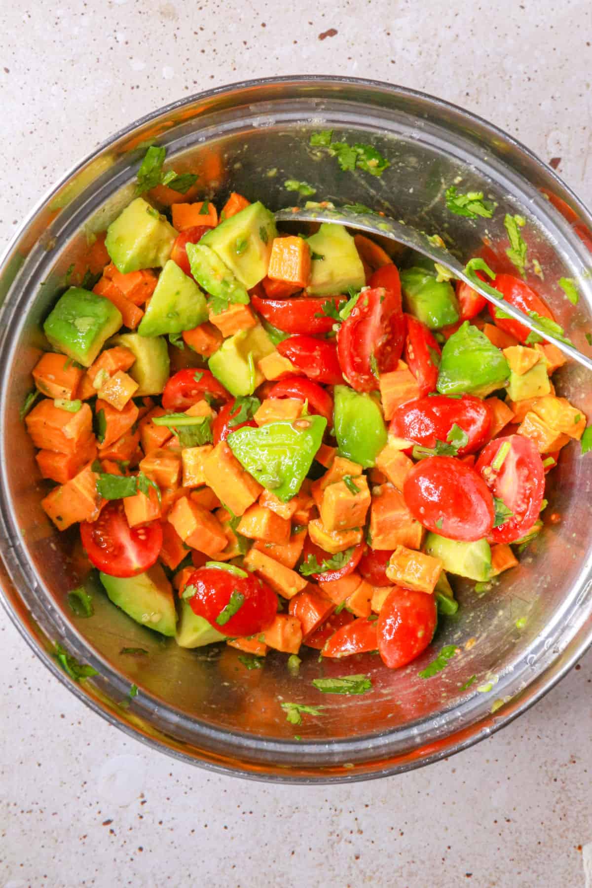 sweet potato salad with avocado in a mixing bowl