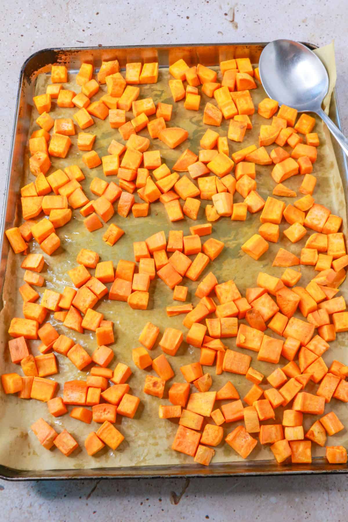 roasted diced sweet potatoes on a baking sheet