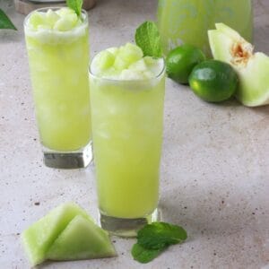 Two glasses of honeydew agua fresca with mint