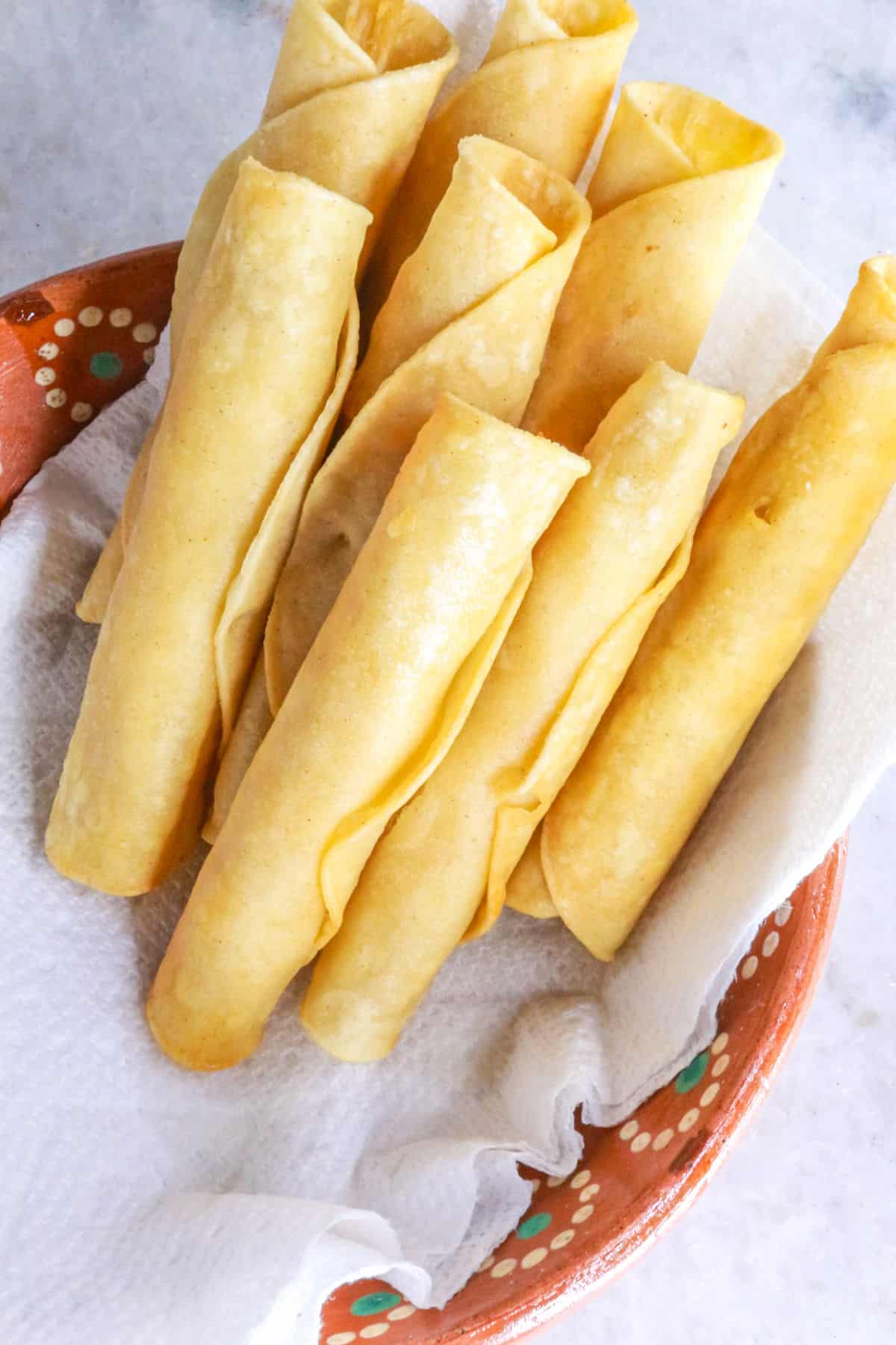 Draining flautas in a paper towel-lined plate