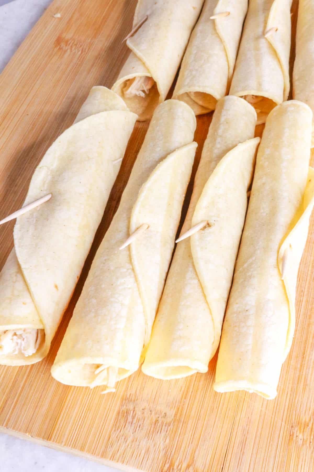 Rolled tortillas filled with shredded chicken.