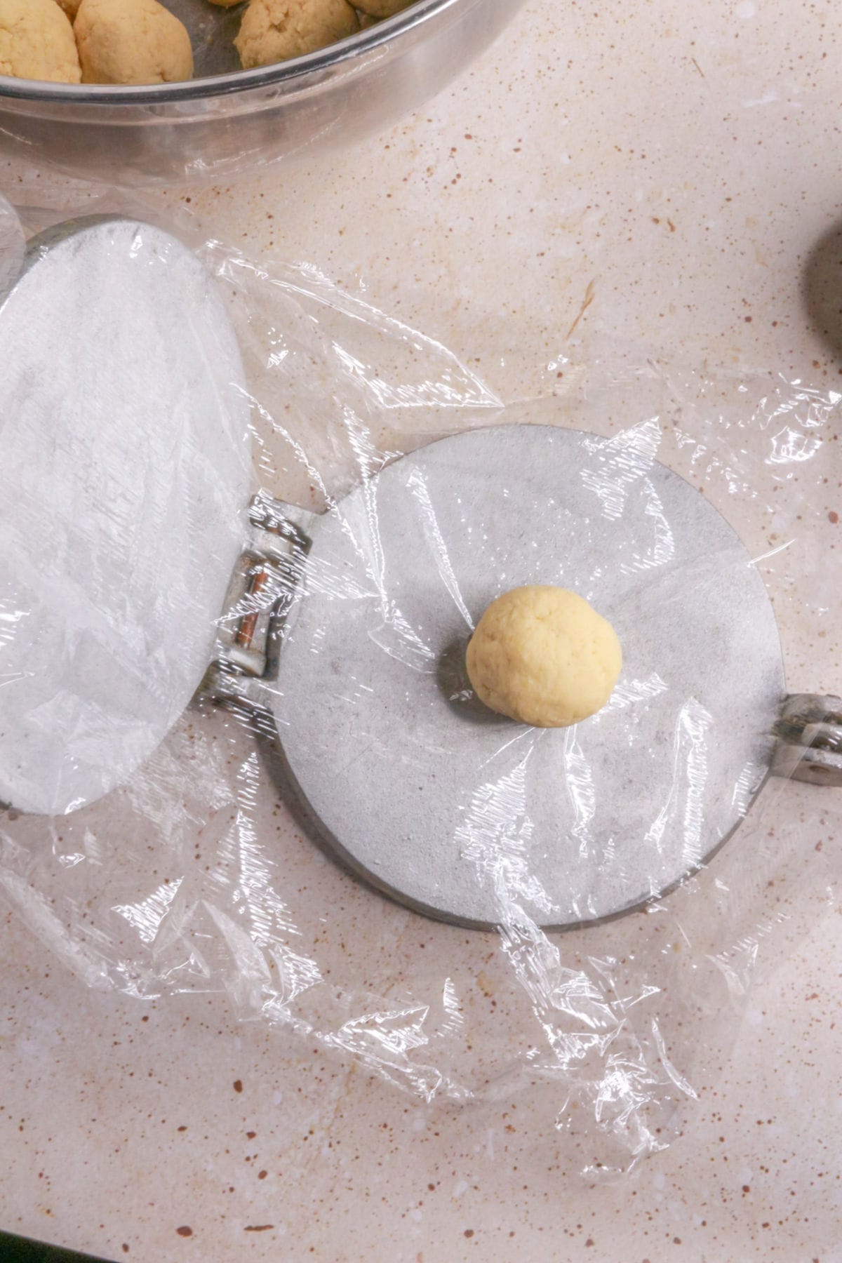 Dough ball on tortilla press