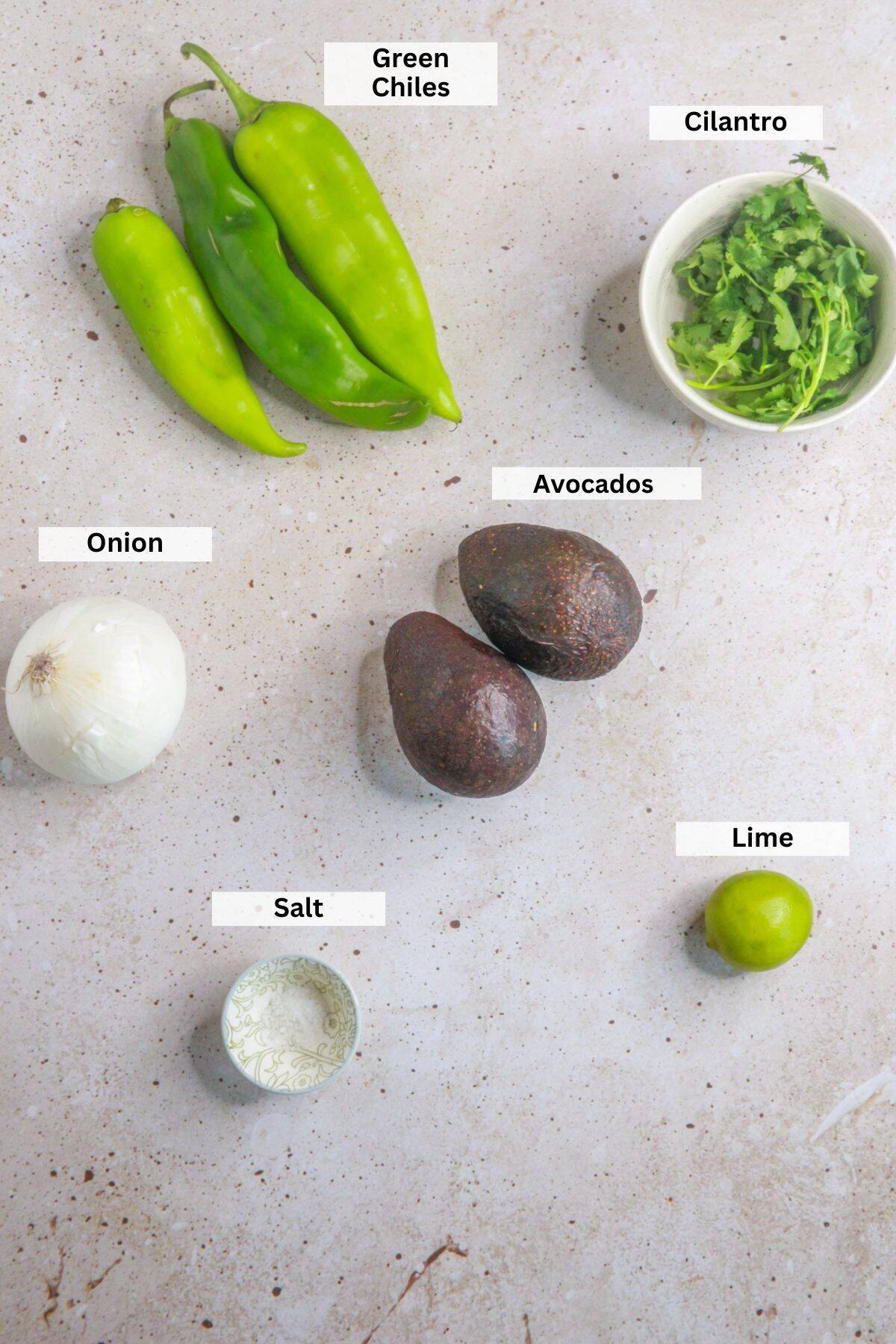 Ingredients for green chile guacamole: green chiles, cilantro, avocados, onion, lime, salt
