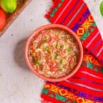 Overhead view of a bowl of salsa cruda (raw tomato salsa)