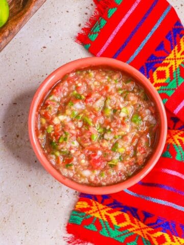 Overhead view of a bowl of salsa cruda (raw tomato salsa)