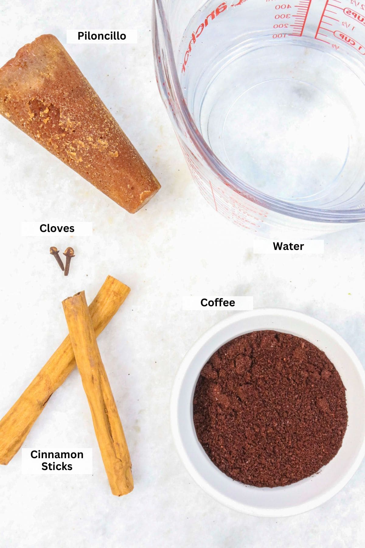 Ingredients for Cafe de Olla Recipe: piloncillo, water, coffee, cloves, cinnamon sticks