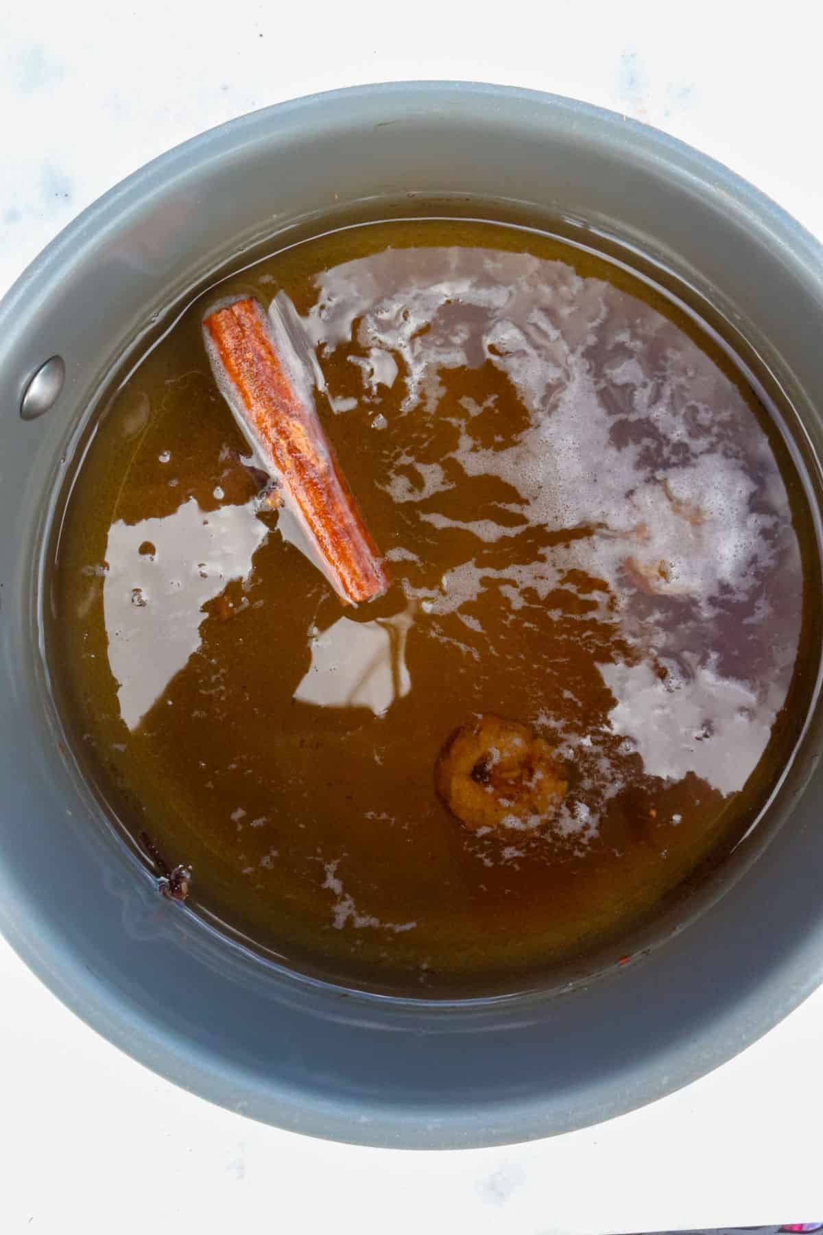 Small pot with water and simmering spices for cafe de olla