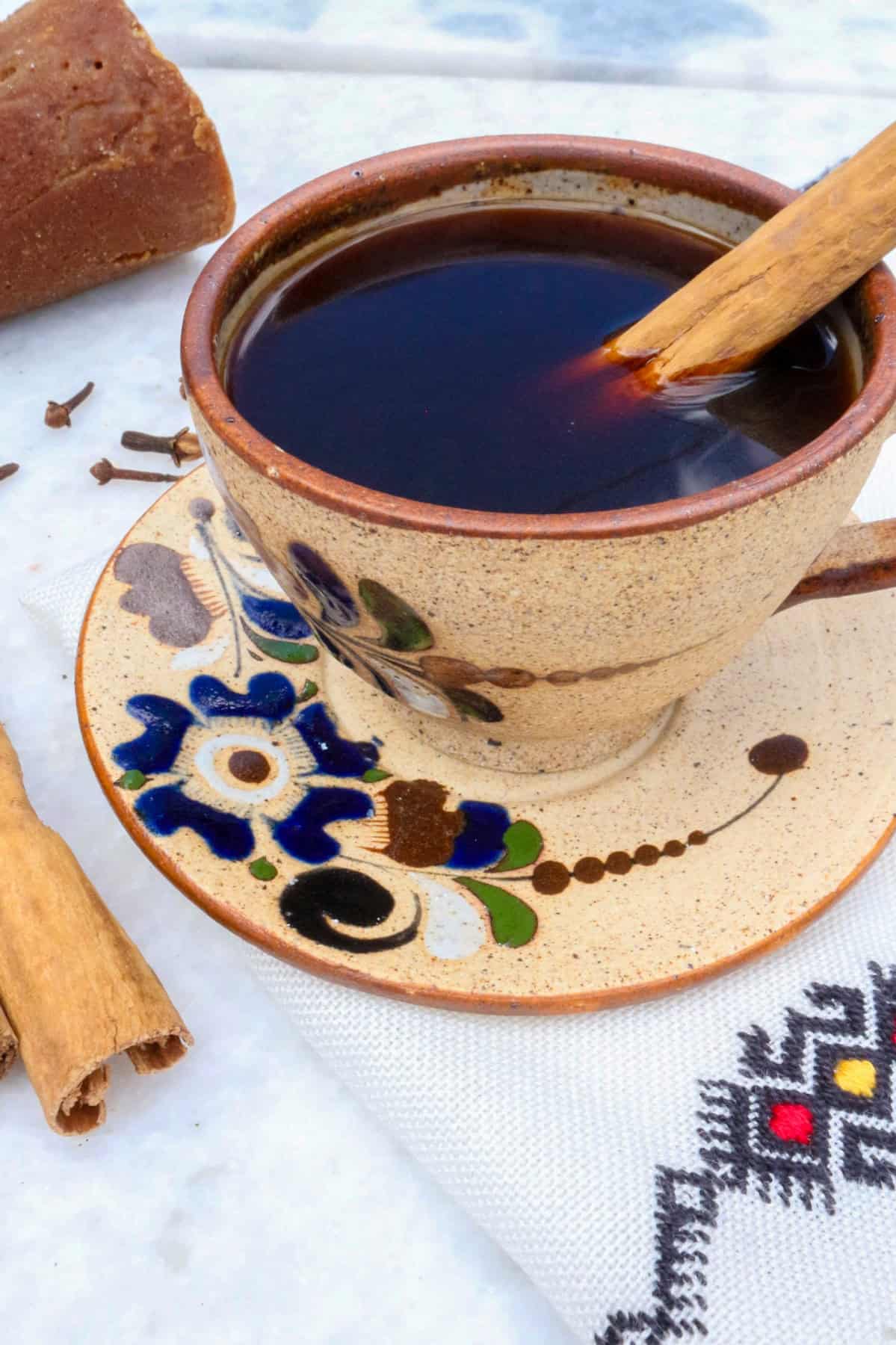 Authentic Cafe de Olla Recipe, coffee in a mug with a cinnamon stick