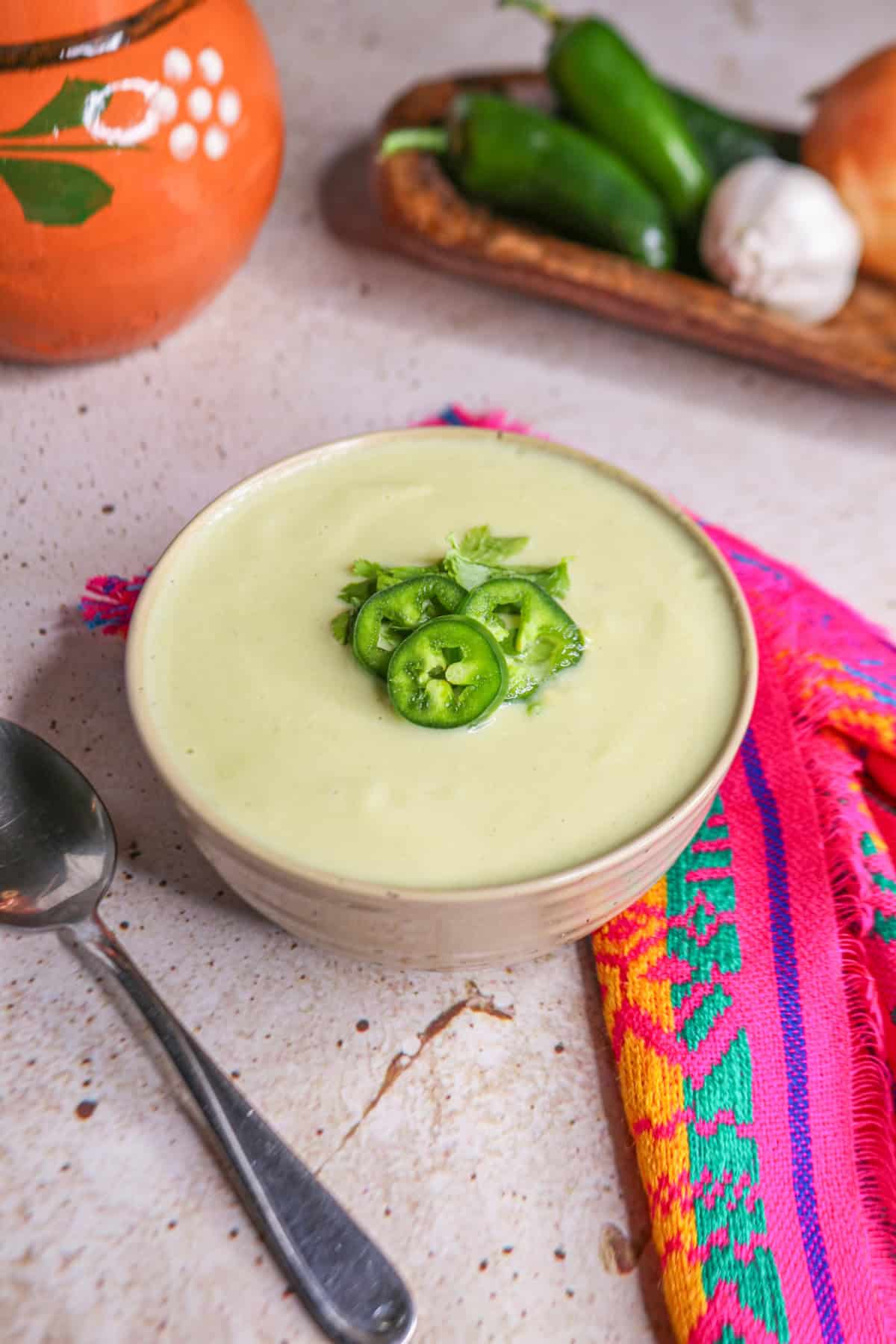 Cream of Onion Soup with Jalapeño in a small bowl topped with jalapeño slices