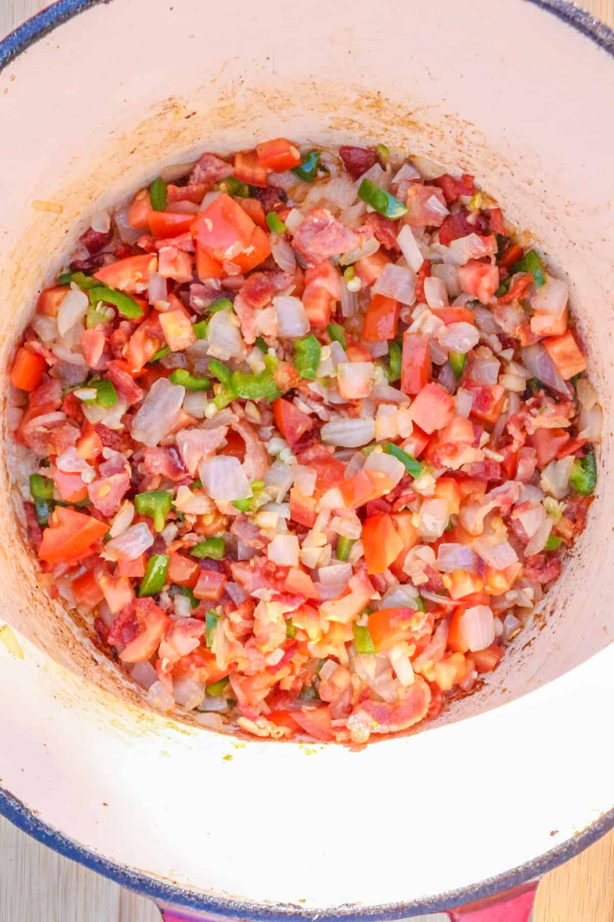 Fried bacon with diced vegetables in a pot
